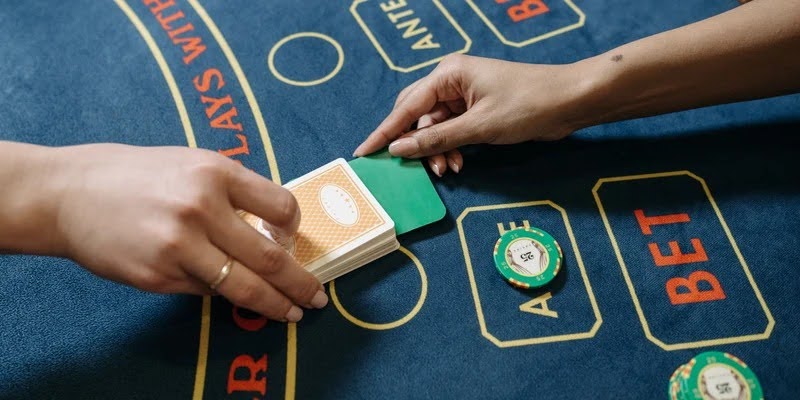 A modern live casino studio setup featuring a professional dealer hosting a blackjack table.